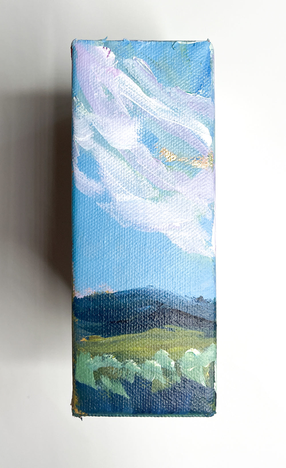 Take a stroll with this impressionist painting capturing a pink and gold sunrise over the Blue Ridge Mountains.
The reflection of gold in the fresh water stream, lined with native reeds and grasses, provides a serene escape for any art lover.
(Nature at its finest!)
