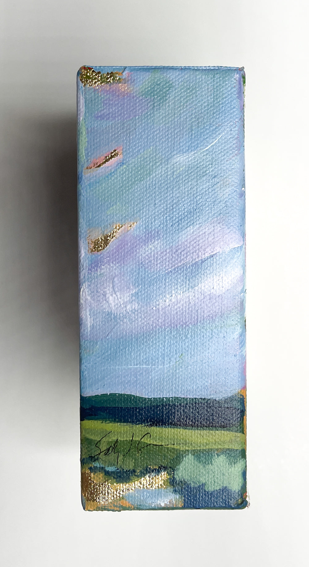 Take a stroll with this impressionist painting capturing a pink and gold sunrise over the Blue Ridge Mountains.
The reflection of gold in the fresh water stream, lined with native reeds and grasses, provides a serene escape for any art lover.
(Nature at its finest!)