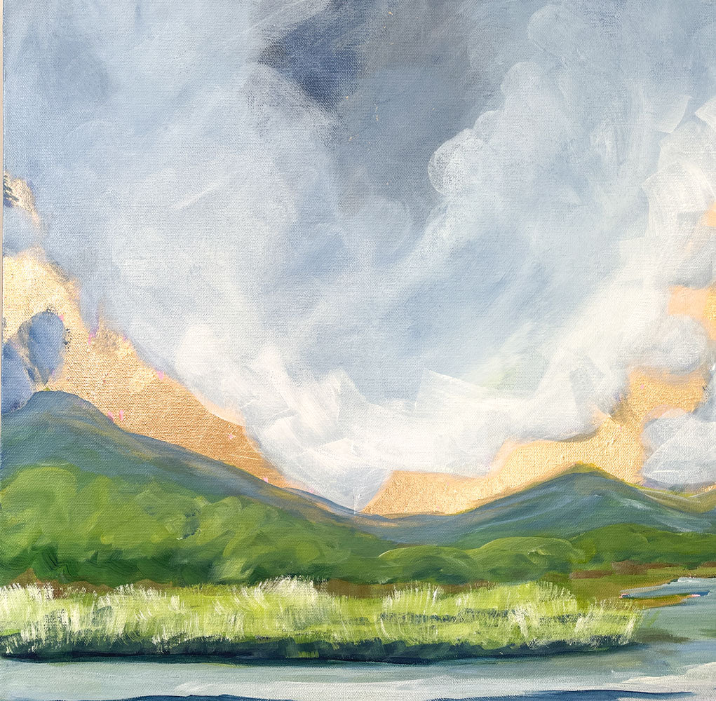 a detail of the 24" x 18" gold leaf landscape painting by Sally J Goodrich. A mix of gold leaf and acrylic paint create gorgeous landscape of the blue ridge mountains. A dramatic moody blue sky with gold rising sun highlights over the mountains, behind native trees and shrubs banking a babbling brook through a field of native grasses.