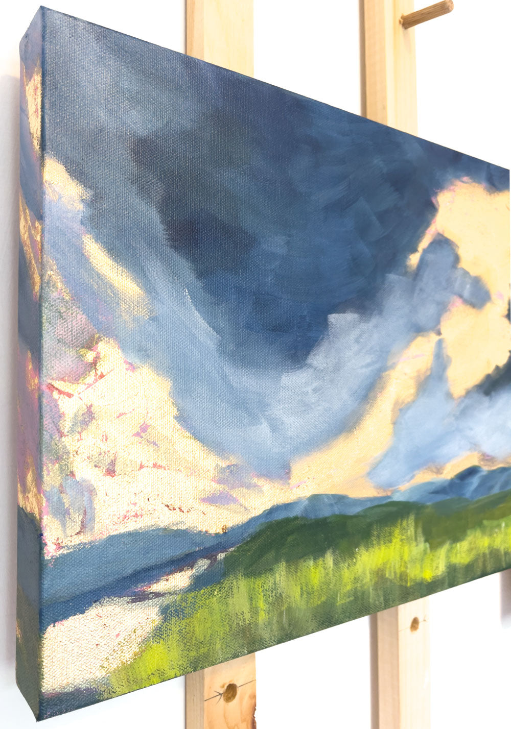 16" x 12"
Gallery wrapped canvas
Acrylic paint and gold leaf
Watch the morning sky come alive with our Startling painting.
This moody masterpiece features a blue-gray sky, painted on all sides and lit by a breathtaking gold leaf sunrise.
The colors are reflected in the river, lined with vibrant yellow-green grasses, and in the distance, the majestic Blue Ridge mountains complete the scene.
It's like taking a walk through a golden heaven on a cloudy spring day.