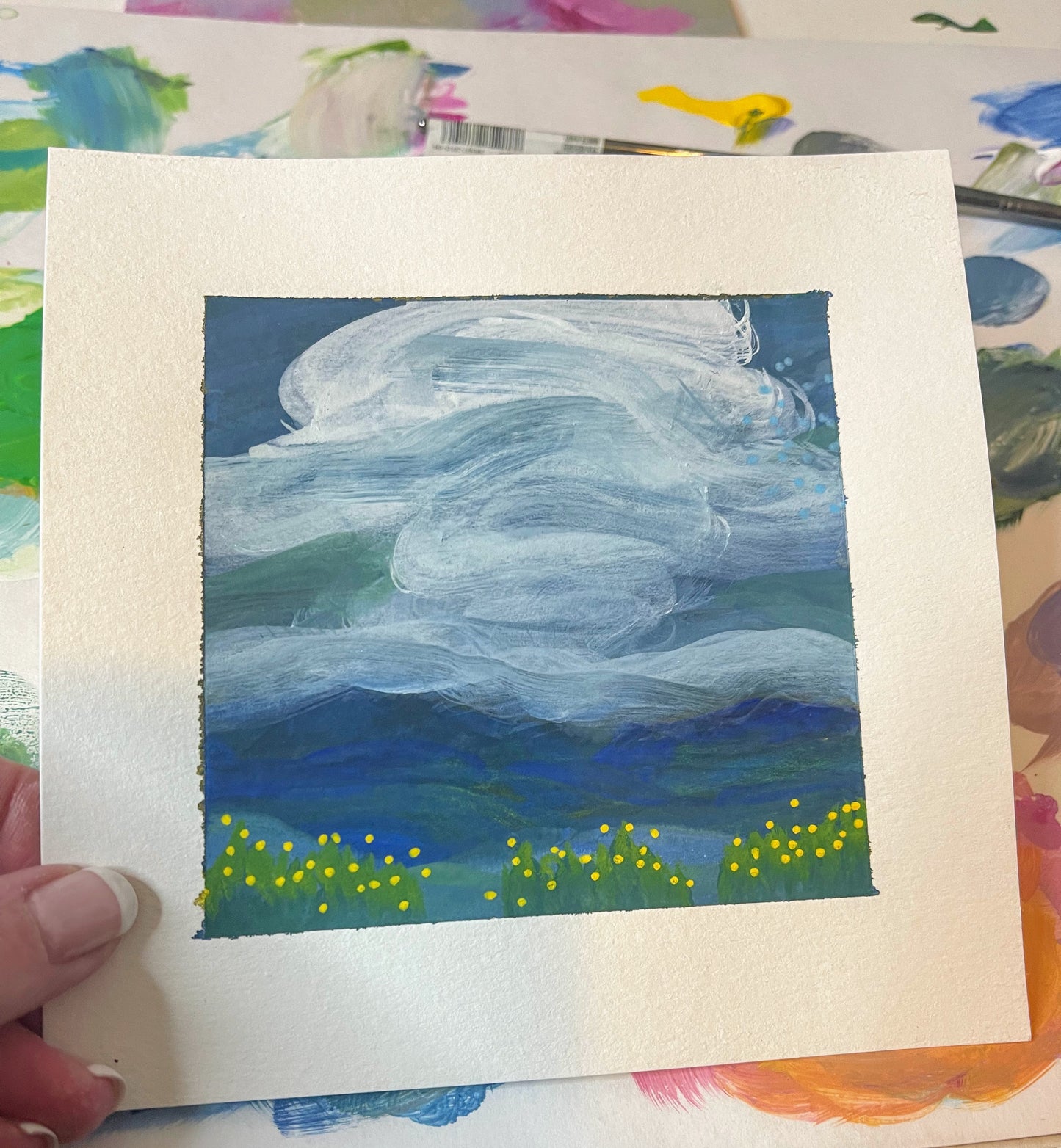 6" x 6"
gouache on cold press watercolor paper
Dare to dream with this impressionistic masterpiece.
Soft white clouds float over a tranquil blue sky, while the majestic Blue Ridge mountains stand tall in the mid ground.
A vibrant meadow of yellow and green flowers adds a touch of whimsy to this charming piece. (Go ahead, take a leap and add a touch of beauty to your home decor!)