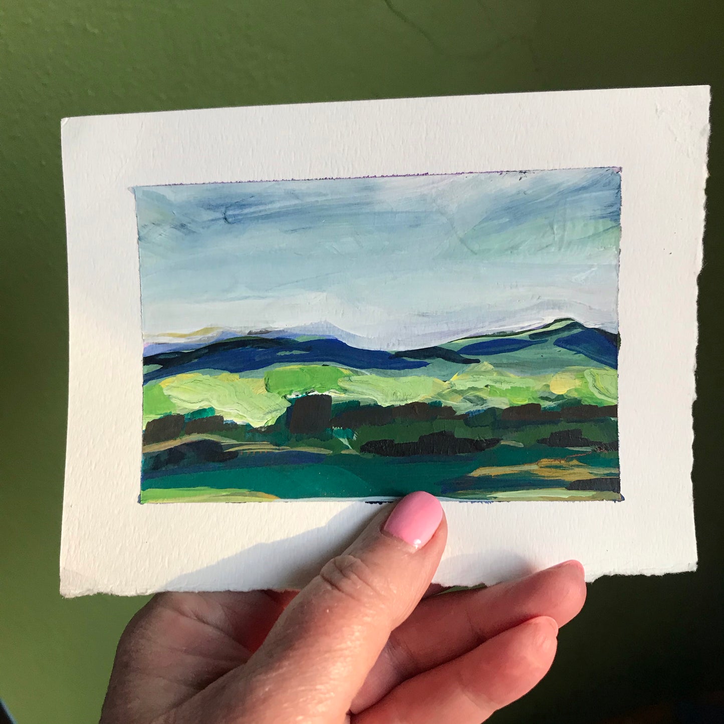 4.5 x 6”
gouache on cold press watercolor paper
Take your walls to new heights with Creatives - a stunning collection of impressionistic, modern landscapes.
Admire the bold blue skies and lush green fields, and get lost in the intricate textures of the blue ridge mountains and green tree line.
Elevate your space with this colorful and vibrant artwork!