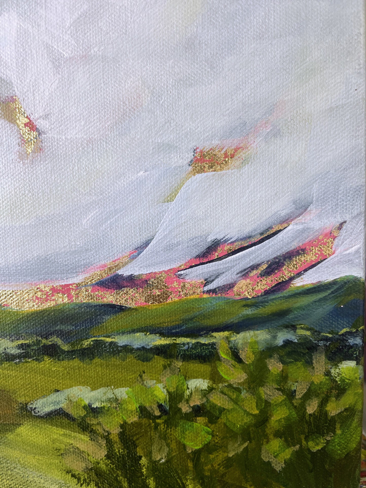 Painting of a mountain landscape with green fields and a cloudy sky.