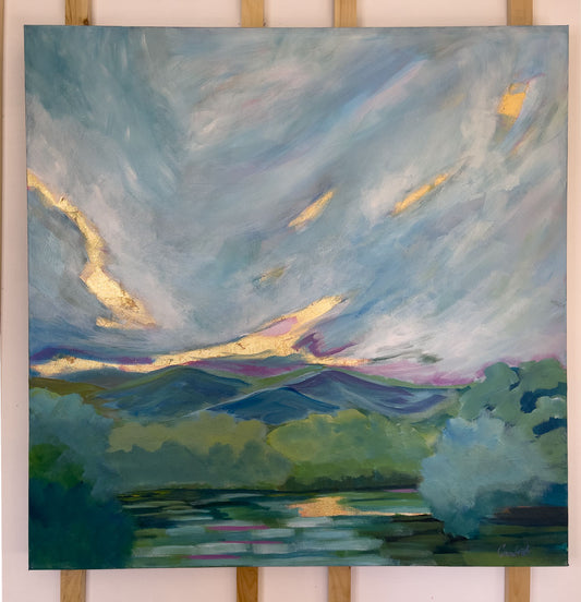 36" x 36"
Acrylic and Gold Leaf on Gallery Wrapped Canvas
Add a spark of nature to your home with Mountain Spring, a modern canvas painting featuring an impressionistic view of a serene lake surrounded by the blue ridge mountains and a fresh forest.
The dramatic sky with swirling clouds and a stunning gold leaf sunrise will instantly transport you to a peaceful and refreshing state of mind.